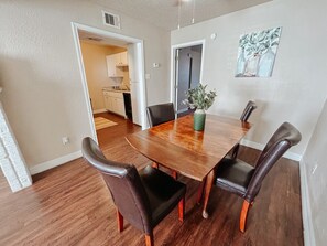Four-person dining table makes for a great spot to eat or gather.