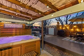 The large back yard offers a hot tub and outside sitting areas surrounded by a privacy fence.