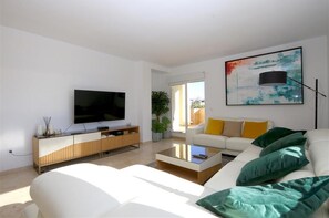 Modern and spacious lounge area with quality seating and balcony access 