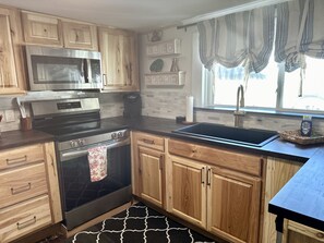 Full kitchen includes a coffee station stocked with decaf coffee and tea.