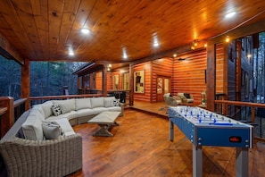 The outdoor entertainment area offers a covered deck with tons of entertainment.