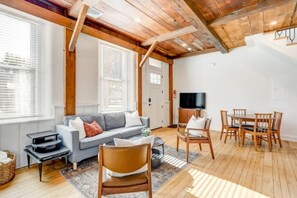 Dining area, TV is on a cabinet with wheels in order to move in front of couch