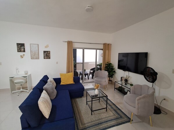 Dedicated work space in the living area with A/C available, and balcony view.