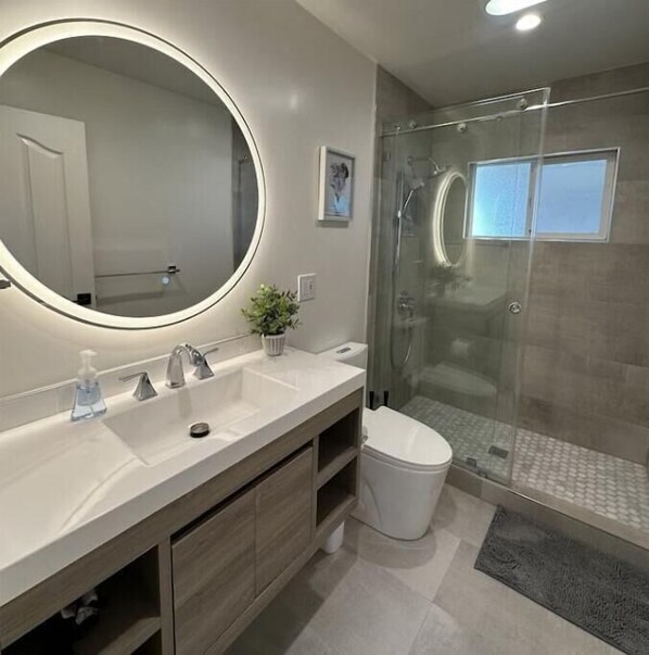 Hallway bathroom with a light-up vanity mirror and brand new vanity