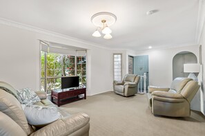 Living room and entry, with garden view.