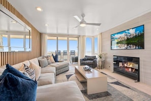 Cozy up by the fireplace in a living space that harmonizes luxury and comfort