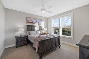 Primary bedroom with Queen bed, smart TV, and ensuite bathroom with shower/tub combo.
