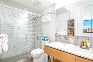 Refreshed in your bathroom with a walk-in shower and a vanity with drawers.