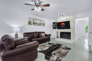 Large wood burning fireplace in the cozy living room