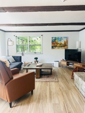 The bright and inviting living room with pull-out sofa.