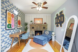 Stylish living room with a fireplace and vibrant art.