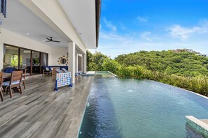 Enjoy sweeping ocean and mountain views and an additional 800 sq ft of outdoor living space at Casa Vista Mar. 
- Gas BBQ 
- Two beverage fridges
- Dining and lounging spaces
- Lifesize games
- Heated, multi-level pool