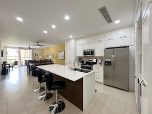 The condo has an updated kitchen featuring stainless steel appliances, in-suite laundry and breakfast bar seating.