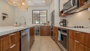 Beautiful and contemporary, this full-equipped kitchen is completely stocked.