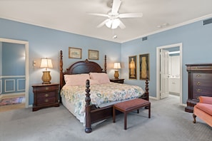 The downstairs Master Suite, features a 4 poster king bed and en-suite bathroom.