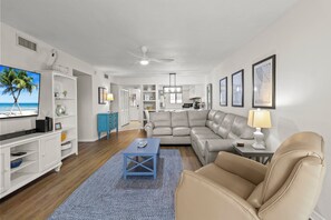 Spacious Living Room With Sectional and Flat Screen TV