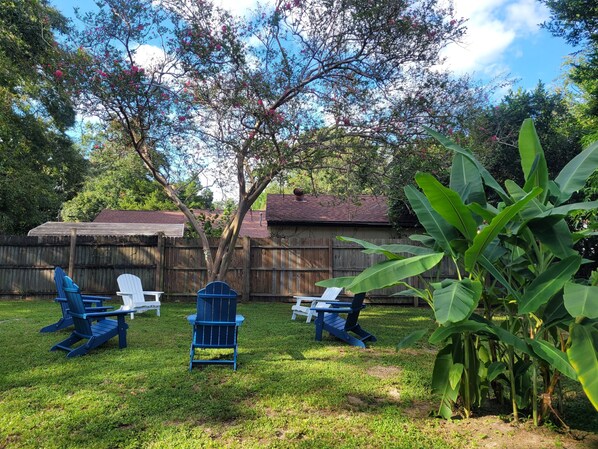 Backyard. Outdoor seating for 6 with a firepit. Must provide own firewood.