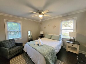 2nd Bedroom with a Queen Bed, night stands, lamps, arm chair & mirror. 