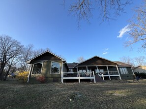 Back of house with porches looking at stunning lake view. 