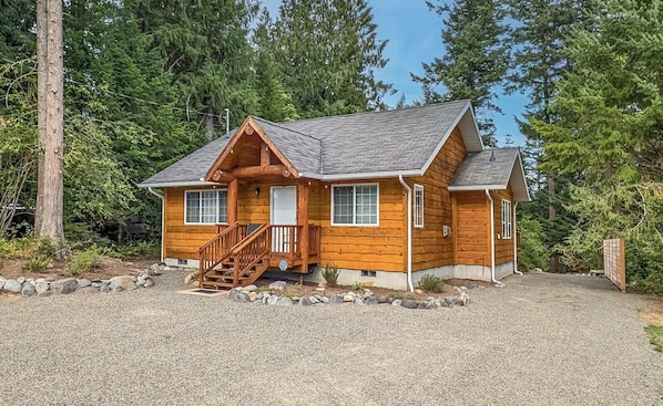 Cedar wrapped cabin with large driveway