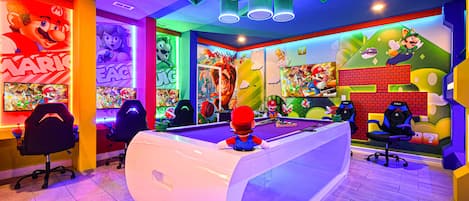 Ultimate gaming paradise with themed décor, neon lights, gaming stations, and a pool table.