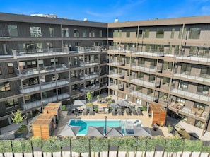 Communal Area: Sparkling blue pool with covered cabanas, sun loungers, and a wheelchair lift.