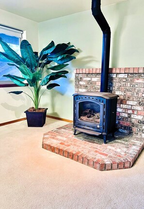 Entertainment room with large comfortable sectional, television and fireplace. 