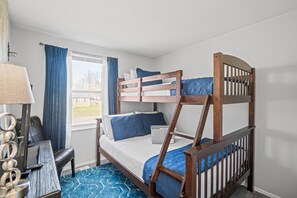 Discover the charm of our third bedroom on the top floor, featuring a twin over full bunk bed, dresser space, and a Roku TV.