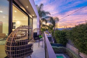 Rattan egg lounge chairs on the balcony of the primary bedroom, indulge the beauty of sunsets.