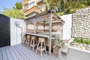 Cabana w/outdoor bar seating and a hot tub.