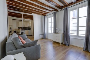 The living area is furnished with a sofa bed.