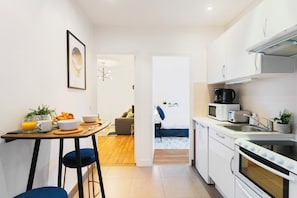 There is a dining table with high-chairs for 2 guests
