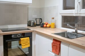 The kitchen is fully equipped to prepare a simple meal