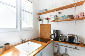The kitchen is fully equipped to prepare a simple meal