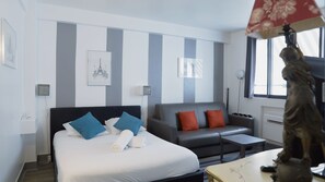 The living area with a double bed and a sofa bed