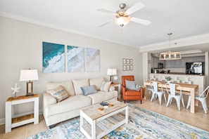 Living room that offers a breathtaking Gulf view, sleeper sofa, 1 recliner, 1 arm chair and a 55" wall mounted SMART TV