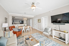 Living room that offers a breathtaking Gulf view, sleeper sofa, 1 recliner, 1 arm chair and a 55" wall mounted SMART TV