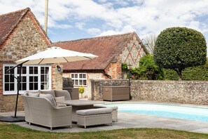 Outside seating area with pool 