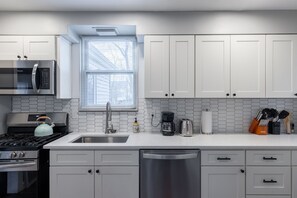 Fully stocked kitchen next to a spacious dining room