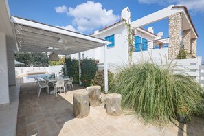 Outside dining area with table and chairs to seat 10 people