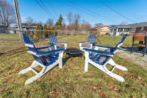 Patio with 4 adirondack chairs and firepit