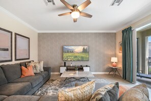 Beautiful, spacious living room featuring its own flat-screen TV, perfect for quality family time.