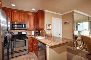 Kitchen features granite countertops and stainless steel appliances