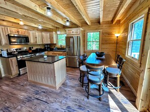 The open-concept kitchen, dining, and living area is perfect for home-cooked meals!