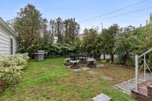 Spacious backyard with patio and dining table