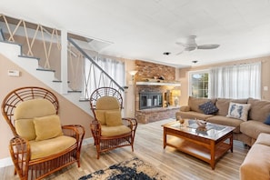 Living room featuring a large sectional couch and smart TV with the ability to log into personal streaming platforms. Note: Fireplace is inoperable