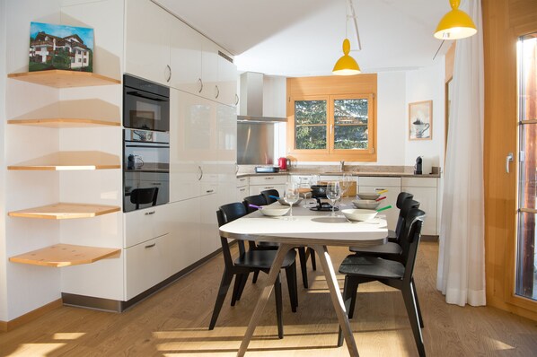 Open-plan dining area with a fully equipped kitchen