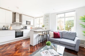 The open-plan living area and the kitchen