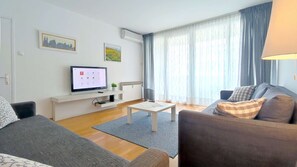 Living room with two sofa beds and TV