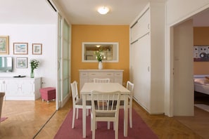 View from the kitchen to the dining area, living room on the left and bedroom on the right.